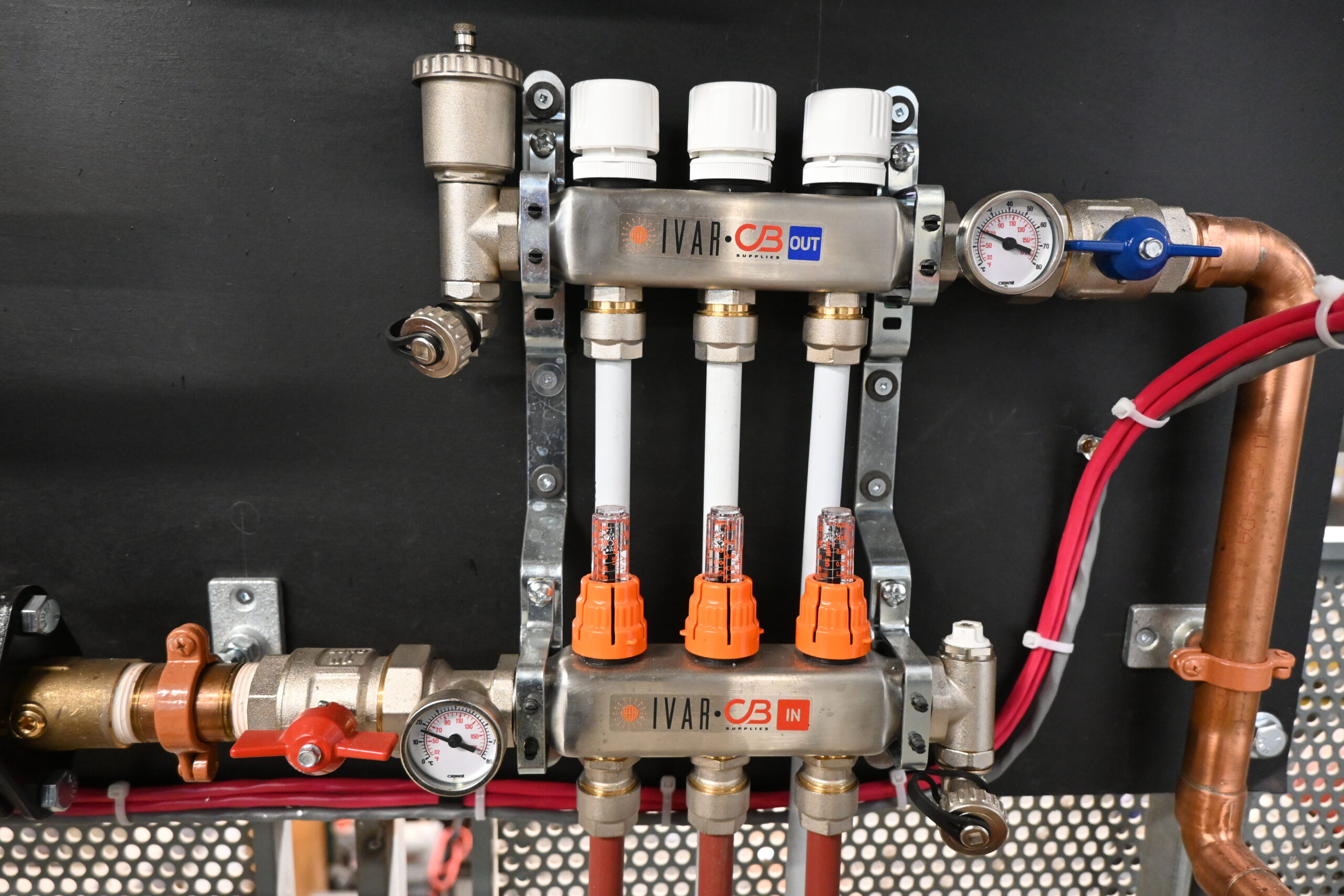 "Picture of a radiant manifold with flow meters"